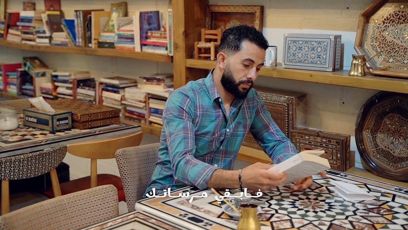 Reading at the table among the shelves