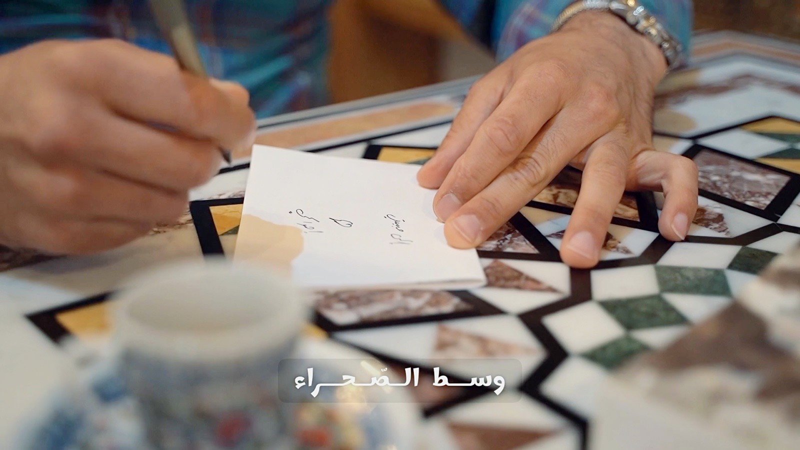 Writing a note beside the coffee