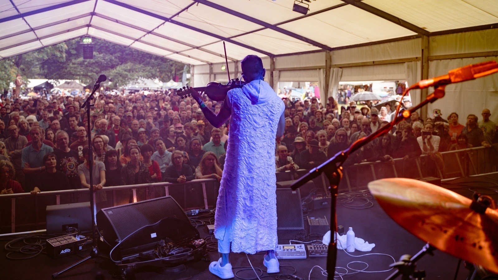 Playing to the packed festival tent, seen from behind the stage