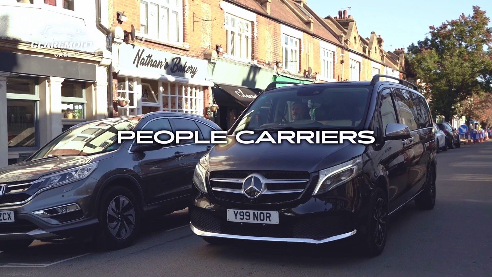 People carriers parked on a high street