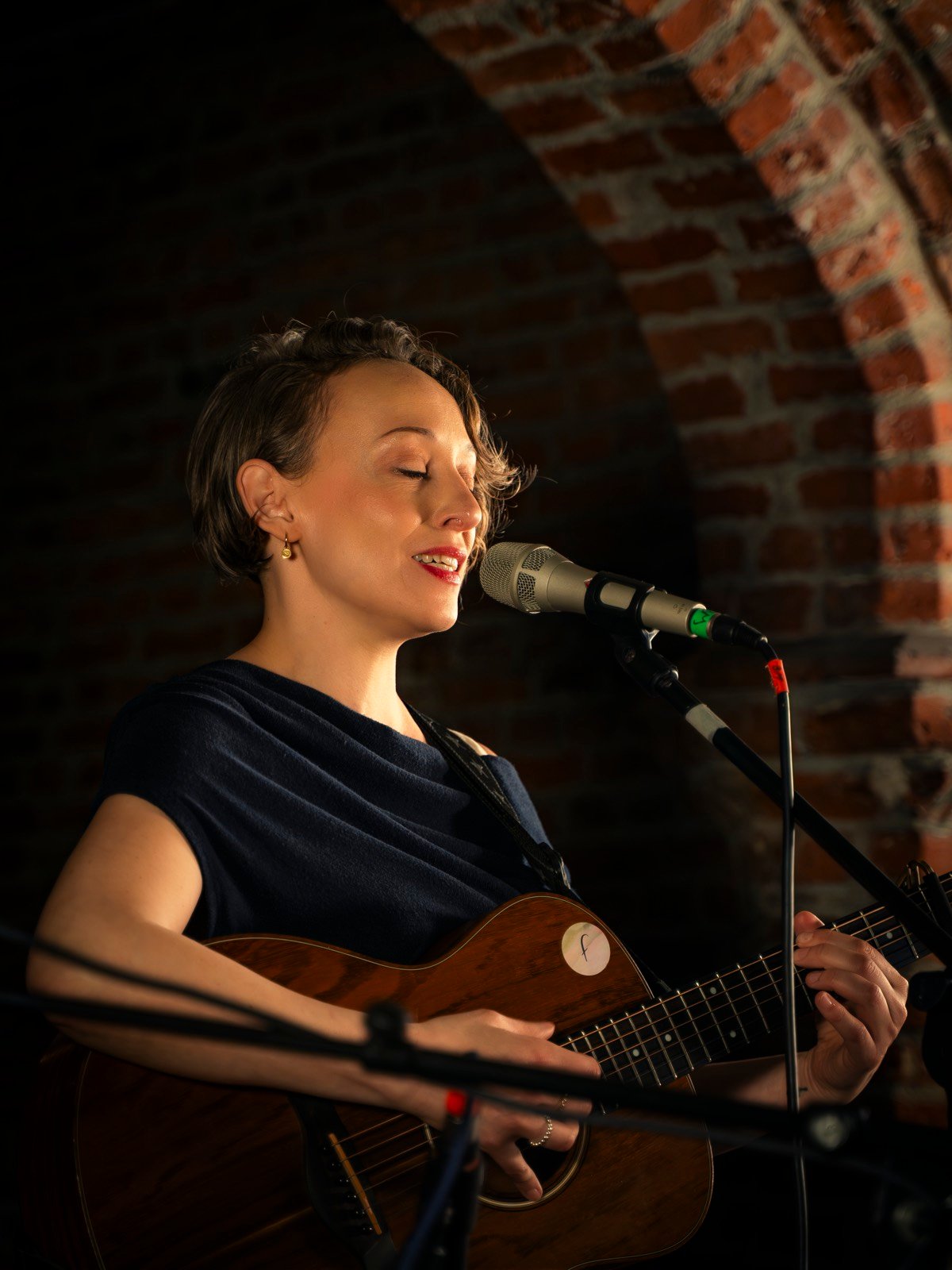 The singer playing guitar