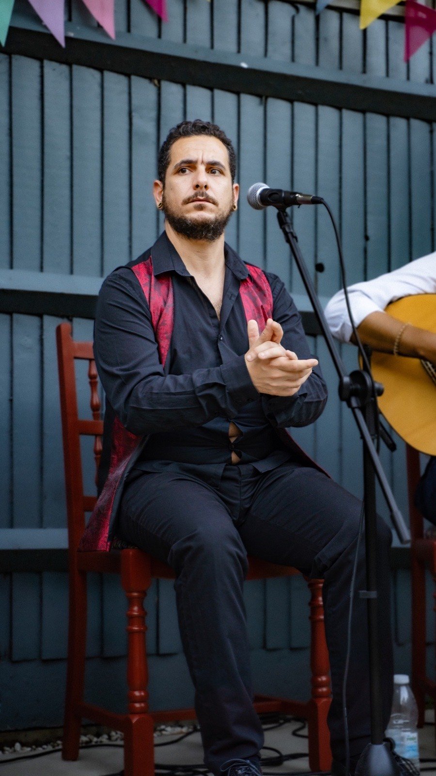 A singer on a red chair by the microphone