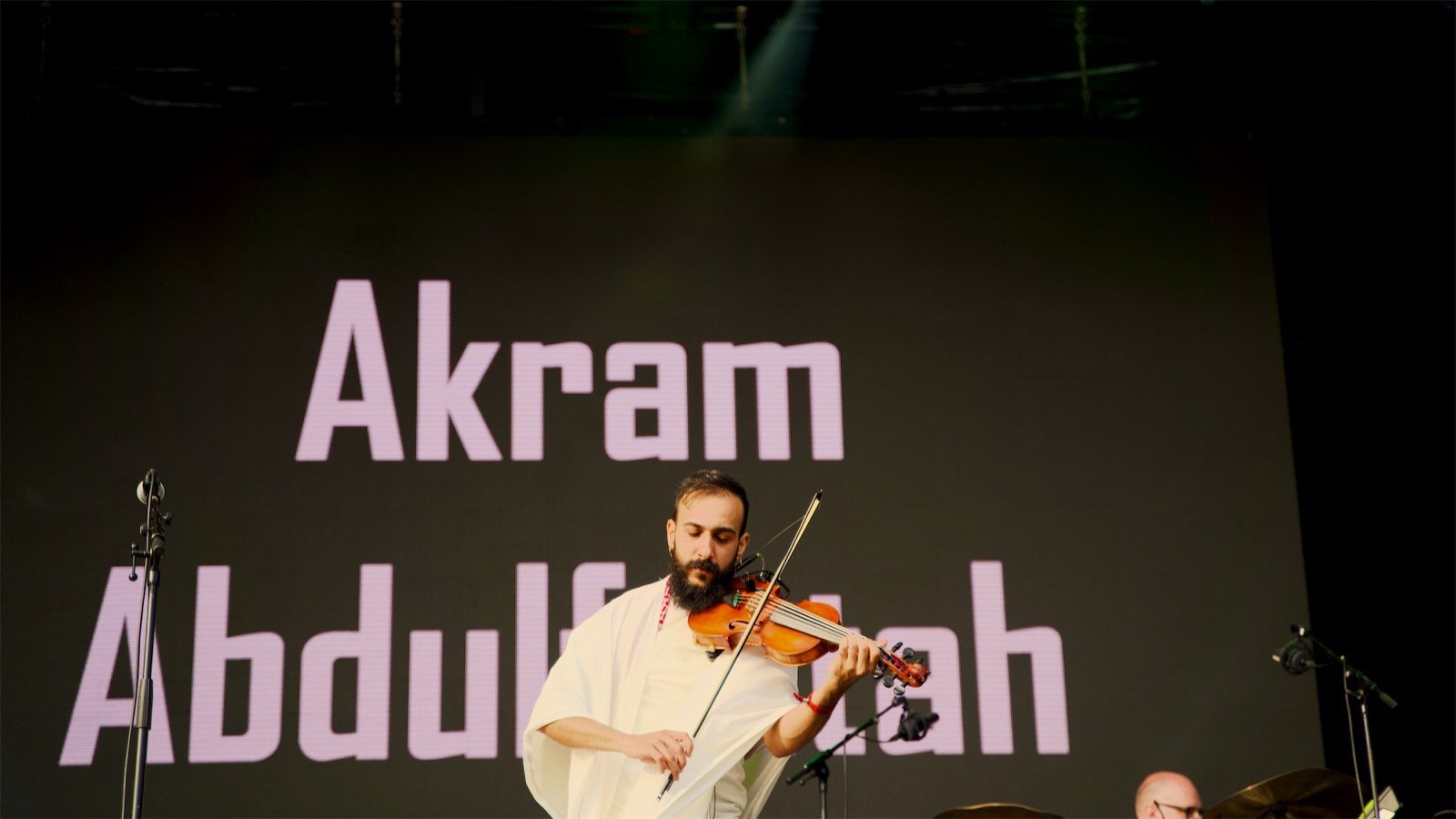 The violin in front of his name on the screen