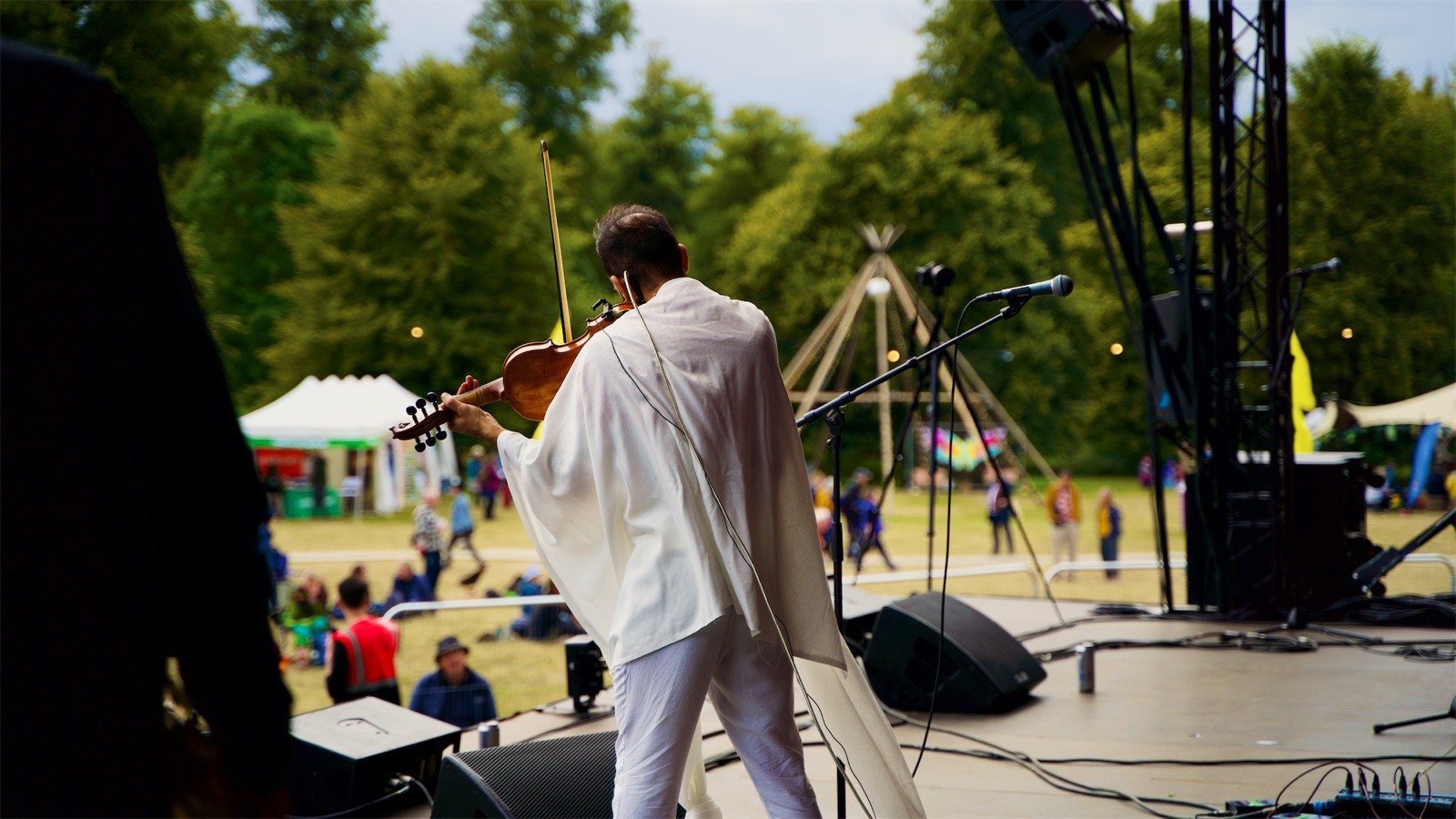 Playing from the side of the stage, the field beyond