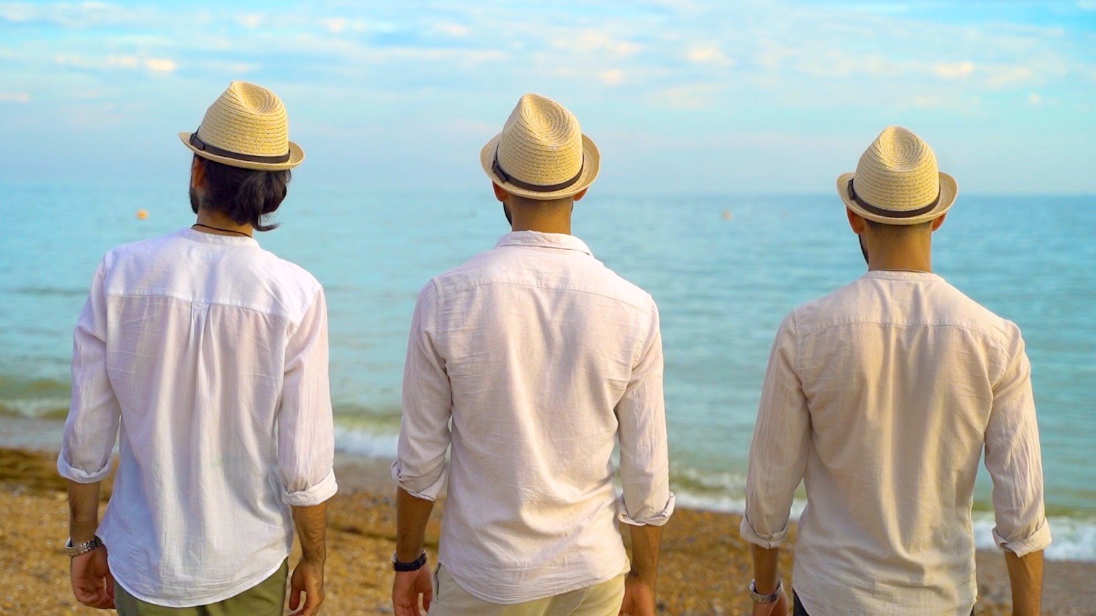 Three men looking out to sea