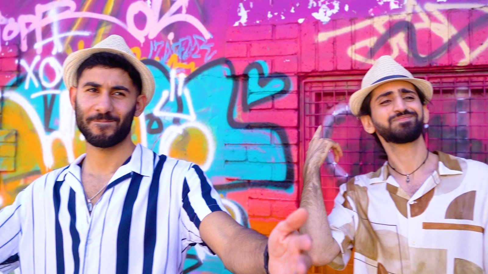 In front of the graffiti wall