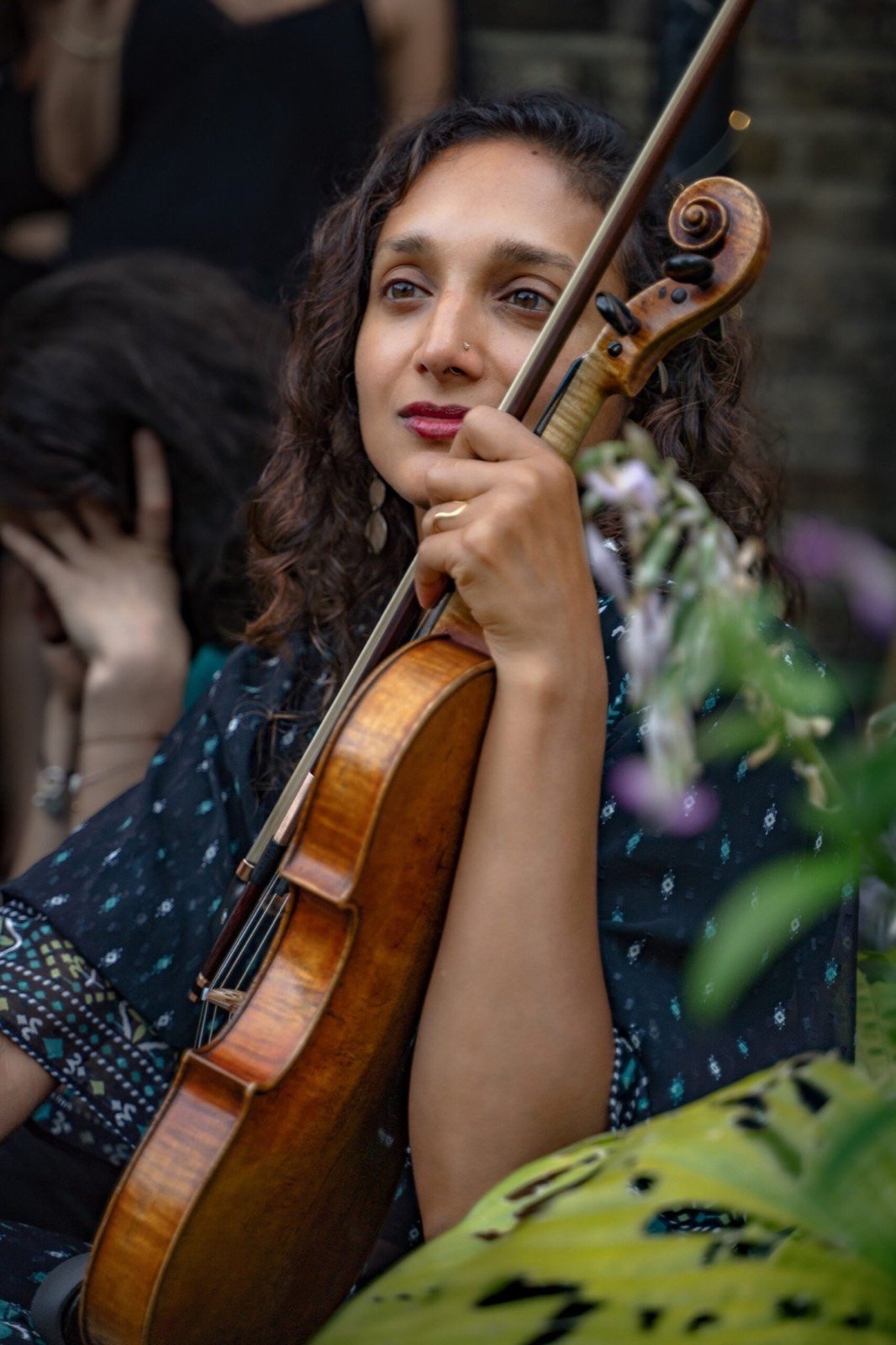 Preetha with her violin among the leaves
