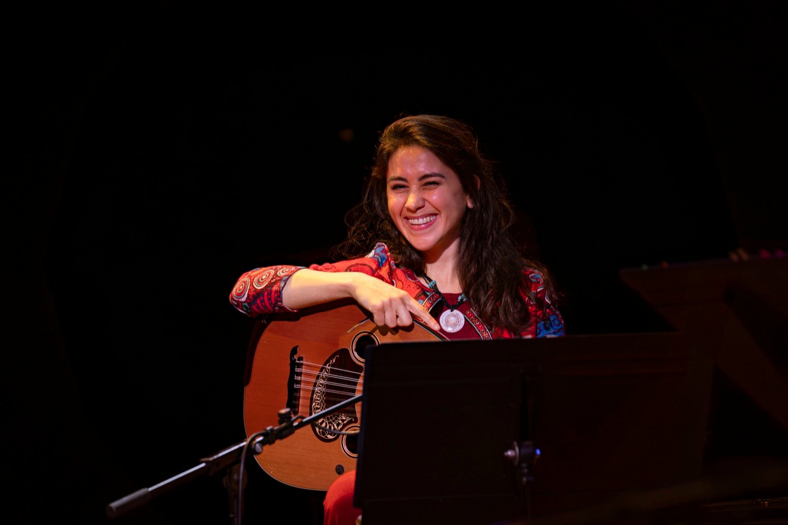 At the oud, smiling