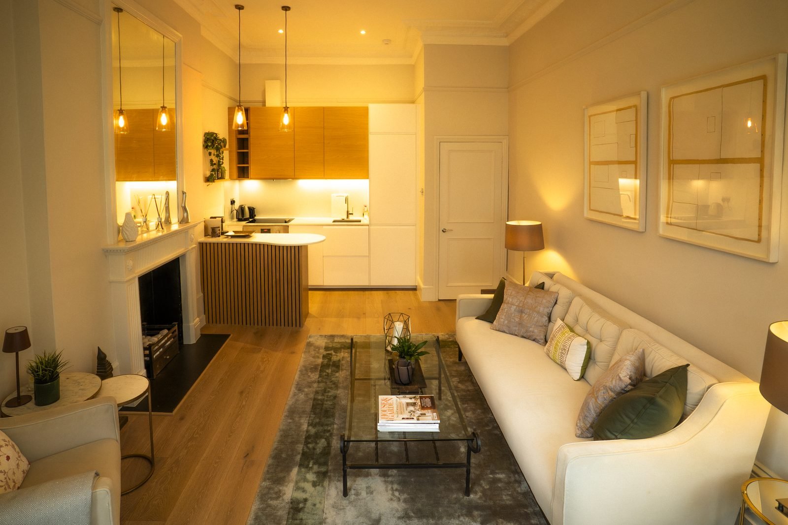 An open-plan flat in Earl’s Court, the kitchen beyond the sitting room