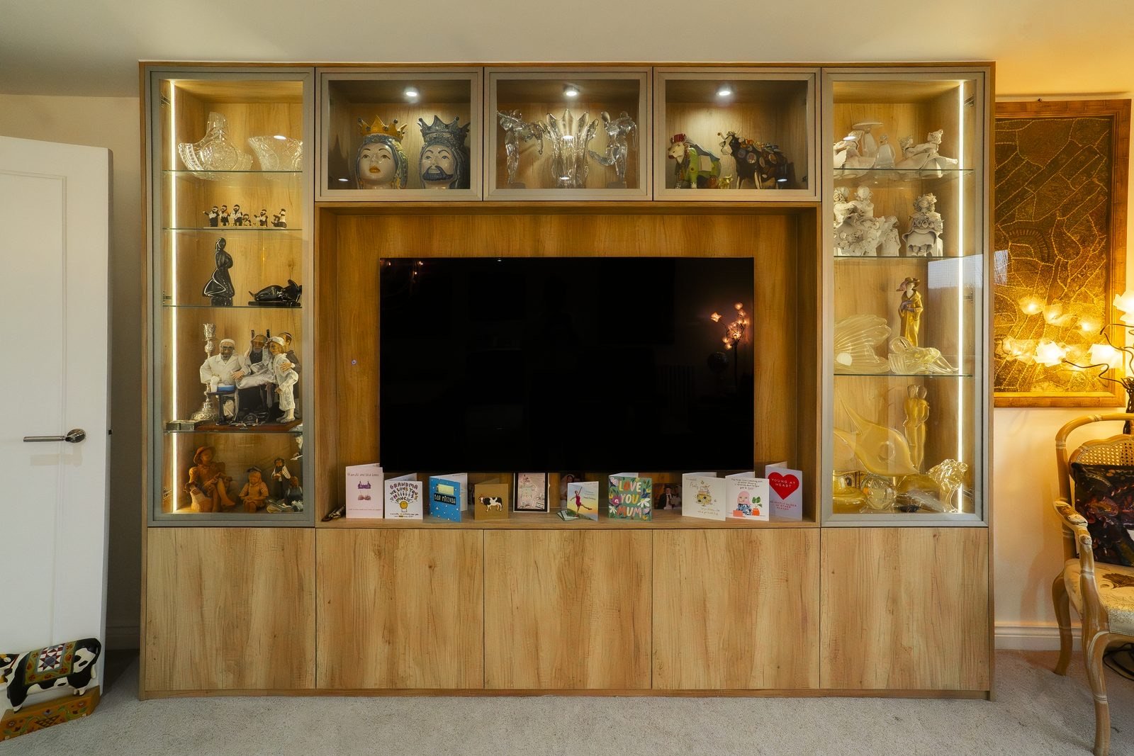 A lit display cabinet built around the television in Edgware