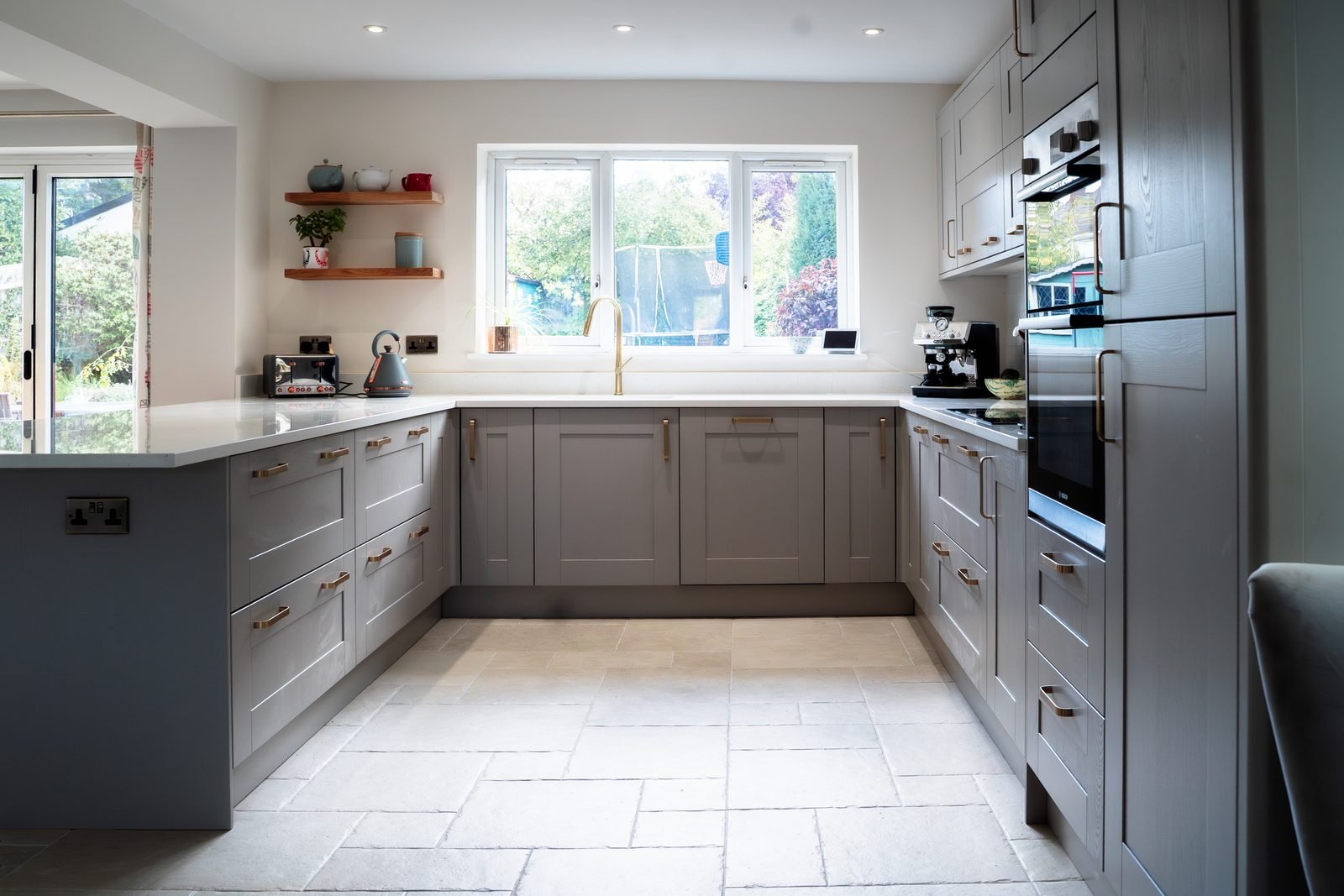 A grey kitchen with a long worktop in Radlett