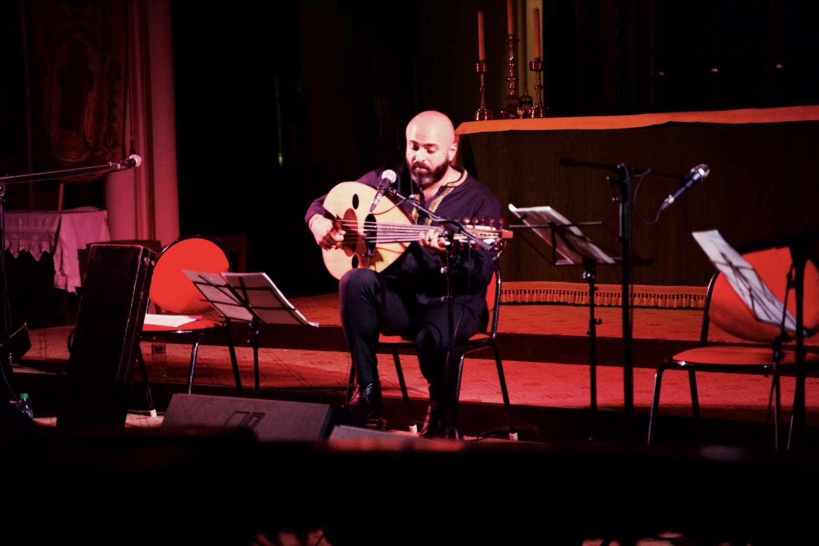 Alone on the stage under the altar