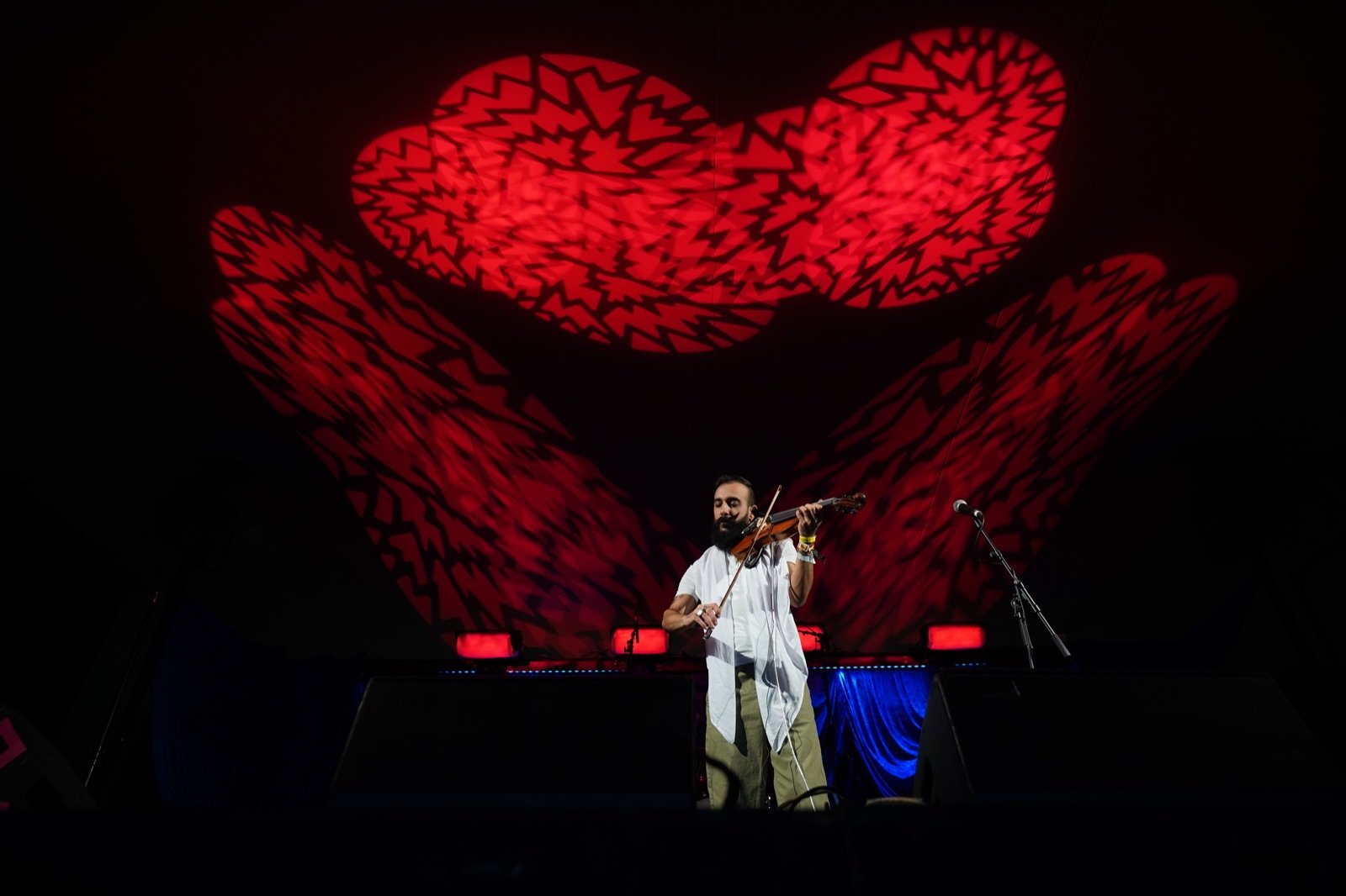 Alone under a red heart of light in the big tent
