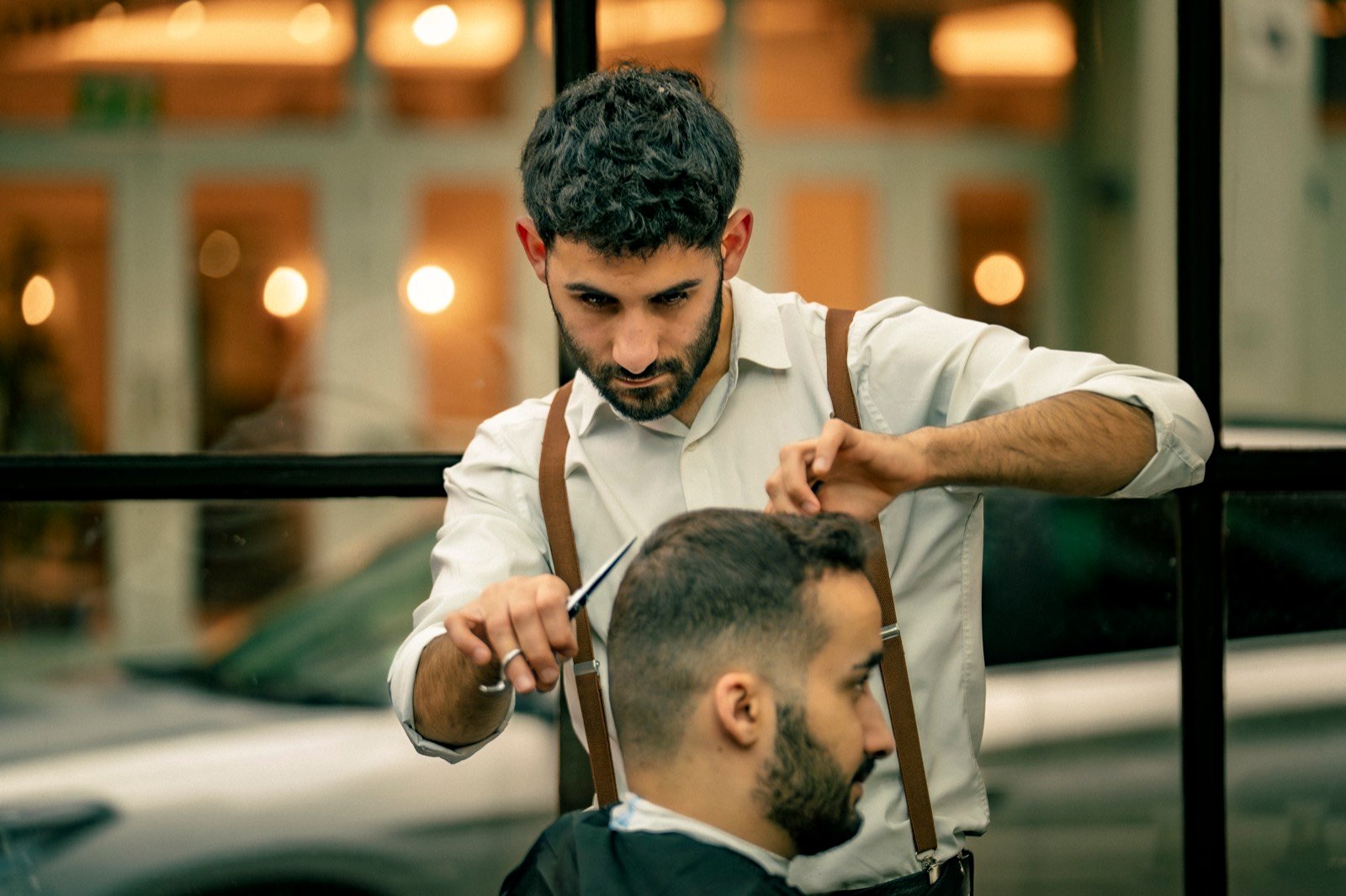 A barber at work by the window