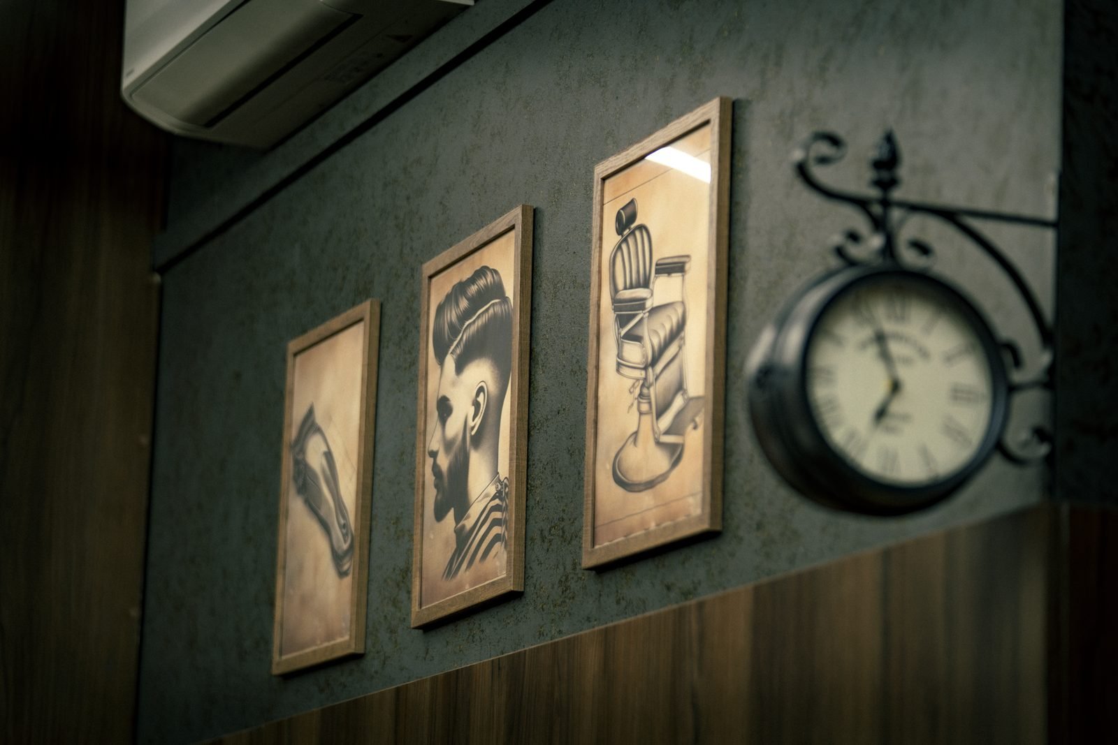Framed barber prints and a clock on the wall