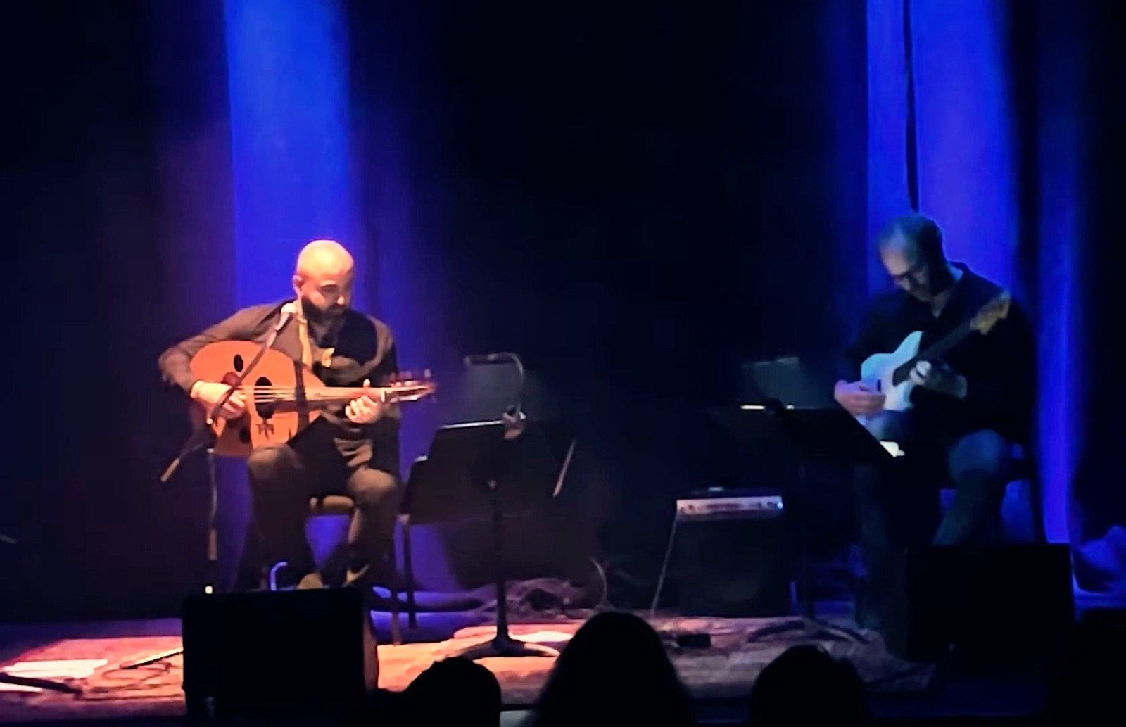 Oud and bass on the blue-lit stage, the audience in front